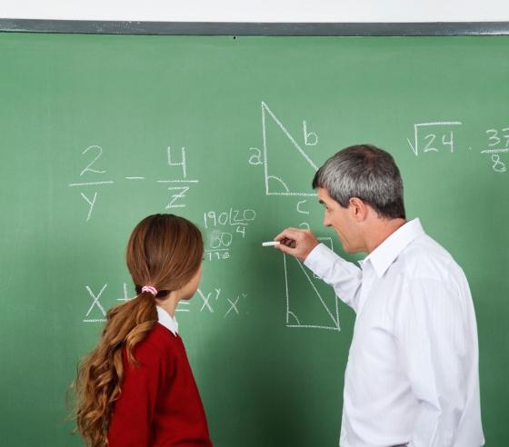 5157758-teacher-and-student-at-blackboard.jpg